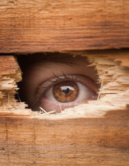 eye spying through a hole