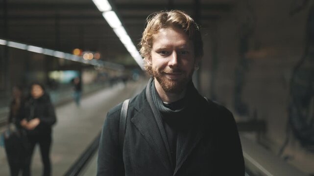 Handsome man commuting on an airport walkalator
