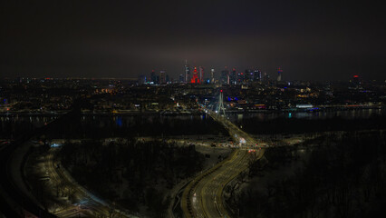 Obraz premium Aerial night view of Warsaw with Swietokrzyski Bridge and skyline