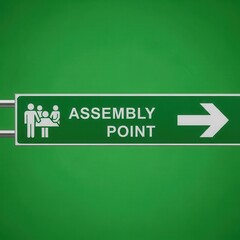 Clear Green Assembly Point Sign Directing People Towards a Designated Location