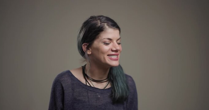 Joyful woman laughing with character, happiness captured in studio