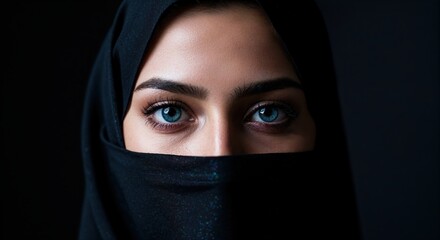 Naklejka premium Mysterious Eyes: A captivating portrait captures the mesmerizing gaze of a woman, her eyes speaking volumes. A striking image highlighting beauty.