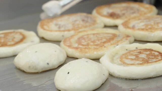 hotteok, Korean Syrup-filled Pancake : Fermented flour dough shaped into balls, filled with a spoonful of brown sugar, and pan-fried in a preheated pan. Brown sugar mixed with cinnamon powder is a com