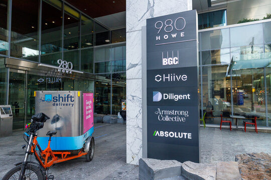 Directory sign at 980 Howe Street building entrance listing tenant companies with Shift delivery cargo bike