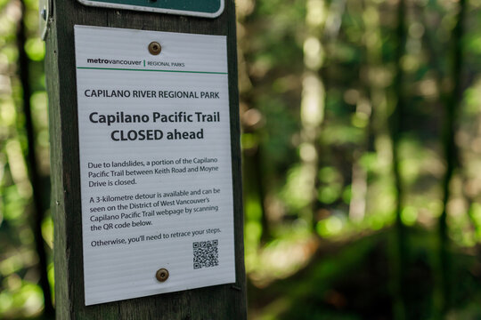 Metro Vancouver Regional Parks sign warning Capilano Pacific Trail closed ahead due to landslides