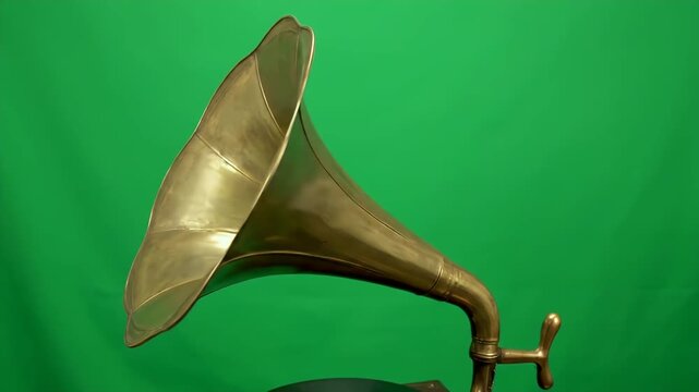 Timeless brass gramophone horn captures classic sound against vibrant chroma key screen for visual projects