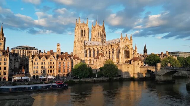 Video frames of historic riverside cathedral city skyline at sunset.