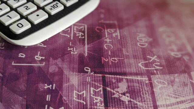 Close-Up Professional Calculator Overlaid with Complex Mathematical Formulas and Equations|A calculator sits atop a surface featuring faded mathematical symbols, representing accounting, data analysis