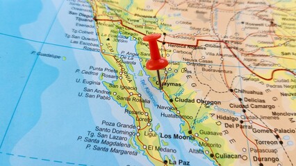 Fototapeta premium View of Guaymas, is a city in Guaymas Municipality, in the southwest part of the state of Sonora, in northwestern Mexico, on a geographical map of America, marked with red push pin