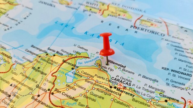 View of Willemstad, is the capital and largest city of Curacao, an island in the southern Caribbean Sea, on a geographical map of America, marked with red push pin