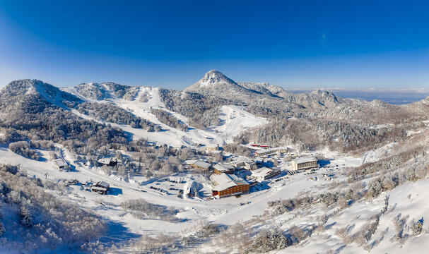 Aerial view of Yokoteyama ski area in Shiga Kogen, Nagano, surrounded by snowy mountains