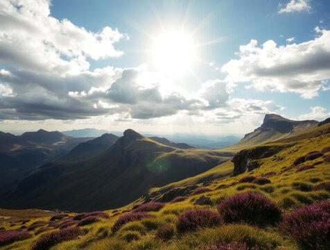 Dramatic mountain landscape with sunbeams breaking through clouds