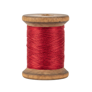 Vintage wooden spool with red thread