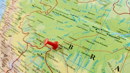 View of Porto Velho, is the capital of the Brazilian state of Rondonia, in the upper Amazon River basin, on a geographical map of America, marked with red push pin