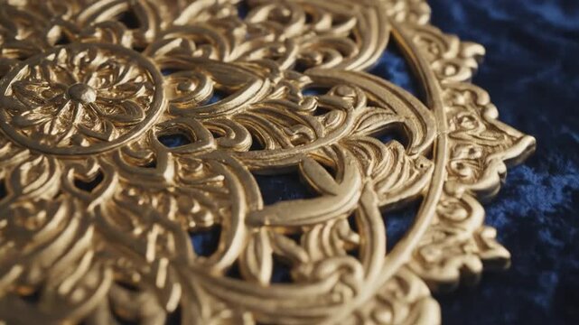 Ornate gold decorative element on a textured blue background