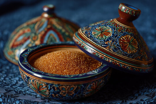 Traditional Moroccan sellou spice mix in ornate ceramic bowls with colorful patterns