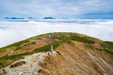 Hiking Route to Happo Pond and  the Japanese Alps mountains landscape with mist background on Hakuba Happo One in Hakuba, Nagano, Japan