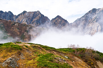 Hiking Route to Happo Pond and  the Japanese Alps mountains landscape with mist background on Hakuba Happo One in Hakuba, Nagano, Japan