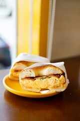 Bagel bread with scrambled egg and bacon.