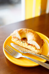 Bagel bread with scrambled egg and bacon.