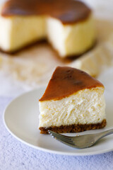 Cheesecake with baking paper on white marble table.
