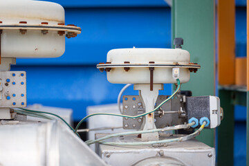 Control valve installed on a chemical pipeline with a large actuator head, used for opening,