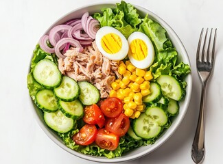 Fresh tuna salad bowl with eggs, cucumber, corn, tomatoes