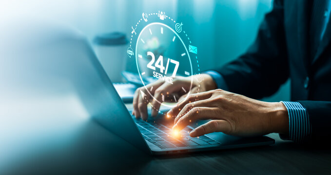 Business professional typing on laptop with glowing 24/7 service clock interface and support icons, illustrating continuous customer assistance, online communication, and digital service operation