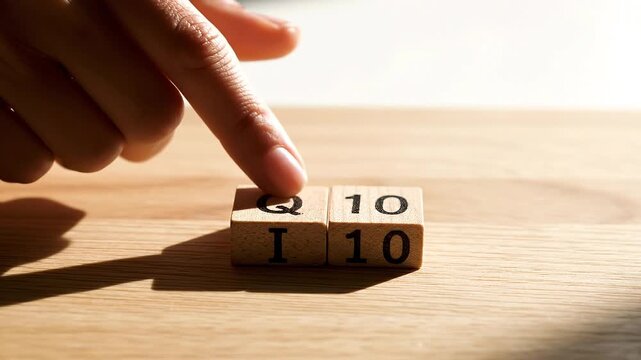 Hand Touching Scrabble IQ Letters