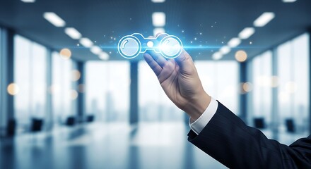 A hand holding glowing binoculars over a blurred office background symbolizing vision