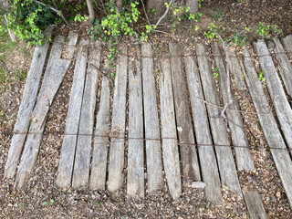 Wooden picket fence fallen over and lying decaying on the ground within the historic former gold mining township of Hill End