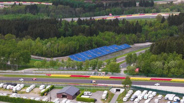 vista contrasts lone white car caravans compact grandstand linear geometry forest enclosure convey pace spa francorchamps belgium spa-francorchamps motorsport circuit caravan rows 