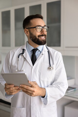 Inspired by medical innovations. Cheerful young male doctor healthcare professional in lab coat...