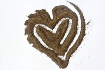 Heart shaped matcha black tea powder isolated on white background