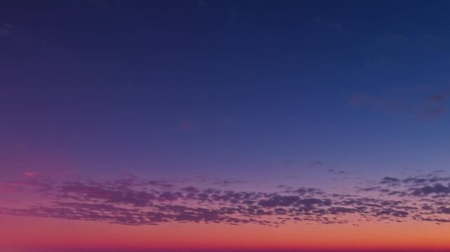 Vibrant sunset sky with layered clouds and gradient colors.
