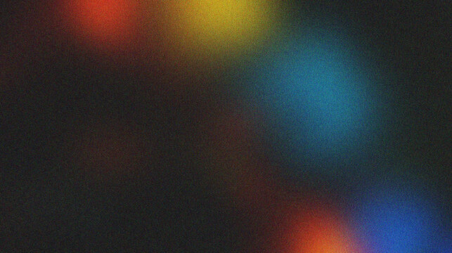 Blurred multicolored dots of light (red, yellow, blue) with a very strong grainy texture all over the surface.