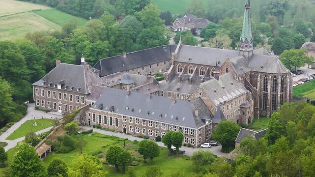 elevated detail clarifies church massing residential wings copper spire under muted light architectural order reads clearly val dieu abbey belgium val-dieu view clarity 