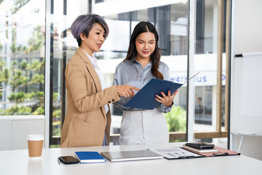 Company executive coaching young personal secretary assistant, team leader or senior manager explaining work duties to junior.