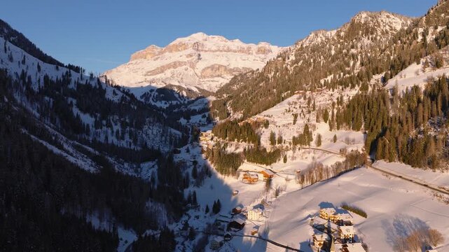 Above Snowscape Mountain Village Of Arabba In The Dolomites, Italy. Aerial Shot