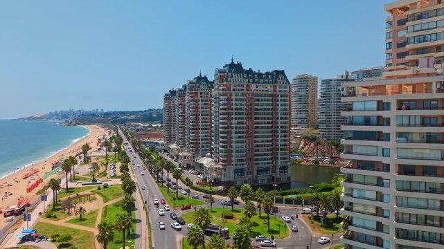 Aerial fly Muelle Vergara Beach, Palm Trees, Traffic and Luxury Resorts in Vina del Mar Chile