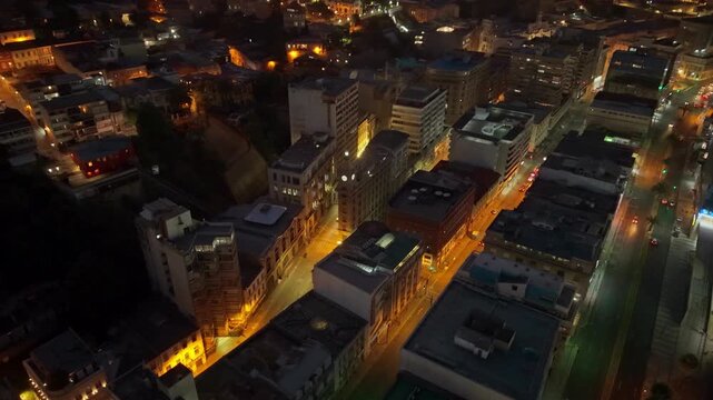Aerial Establishing Night fly Valpara&iacute;so City Lights, Traffic at Reloj Turri Landmark in Chile