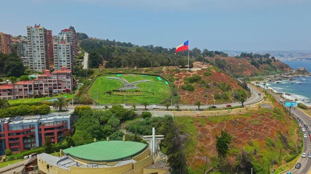 Aerial Drone fly Chilean Flag, Coastal Road Traffic and Resort Buildings in Re&ntilde;aca Vi&ntilde;a del Mar Chile