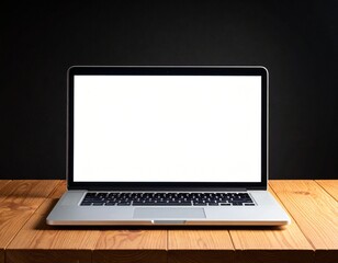 Fototapeta premium One silver modern laptop with empty white screen on wooden table in a dark room on black background. 