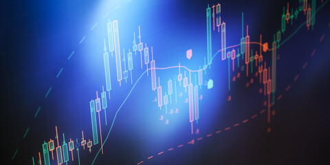 stock market candlestick chart on digital screen with blue backlight, technical analysis, trading...
