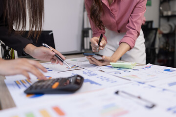 Fototapeta premium Business people analyzing financial graph charts and data dashboard on virtual screen with market research report for strategic planning and investment success.