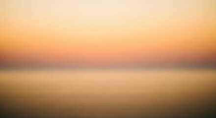 Fototapeta premium Golden sunset over calm water horizon with warm soft light and peaceful reflection