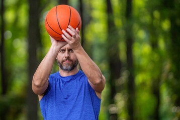 Summer activity. Man with basketball ball in forest. Professional basketball player training outdoor. Guy has sport motivation. Sport and hobby. Dunk in basket. Slam dunk in motion, copy space © be free