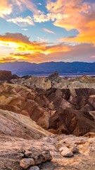 Scenic vista of layered earth formations at sunset with colorful clouds