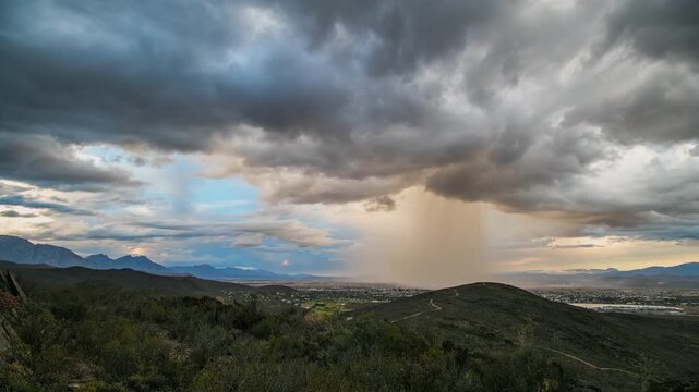 Microburst rain downpour over rural townscape, copyspace time-lapse