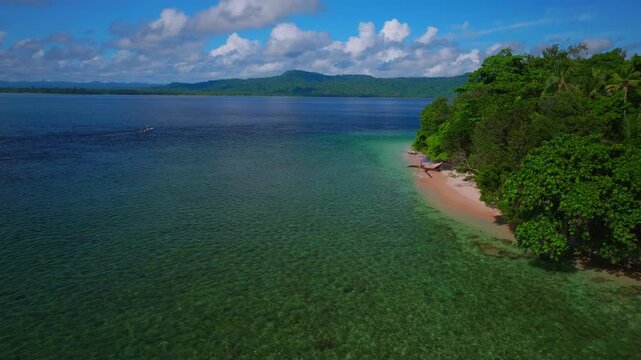Yuo Island village Wewak Sepik Region Fishing boat aerial drone Papua New Guinea PNG Papua Niugini sunny blue sky untouched coastline beach coral reef Madang Bismarck Sea Pacific Ocean forward pan